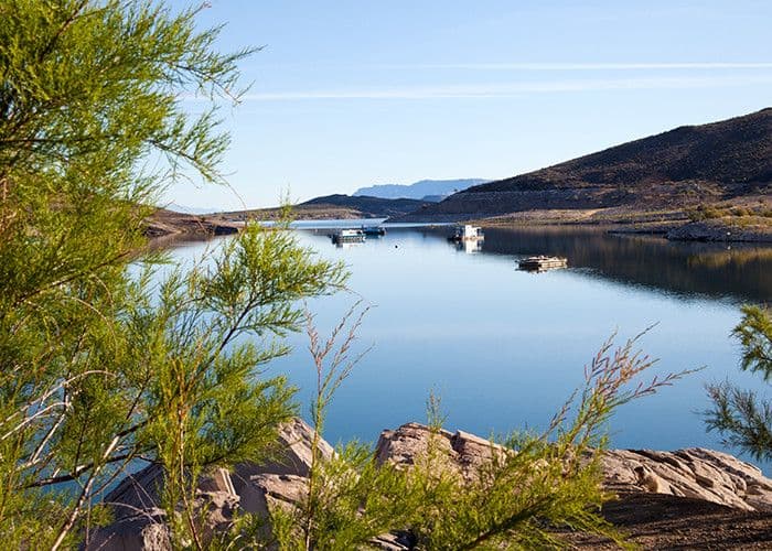 View of Elephant Butte Lake with boats and desert mountains in the background