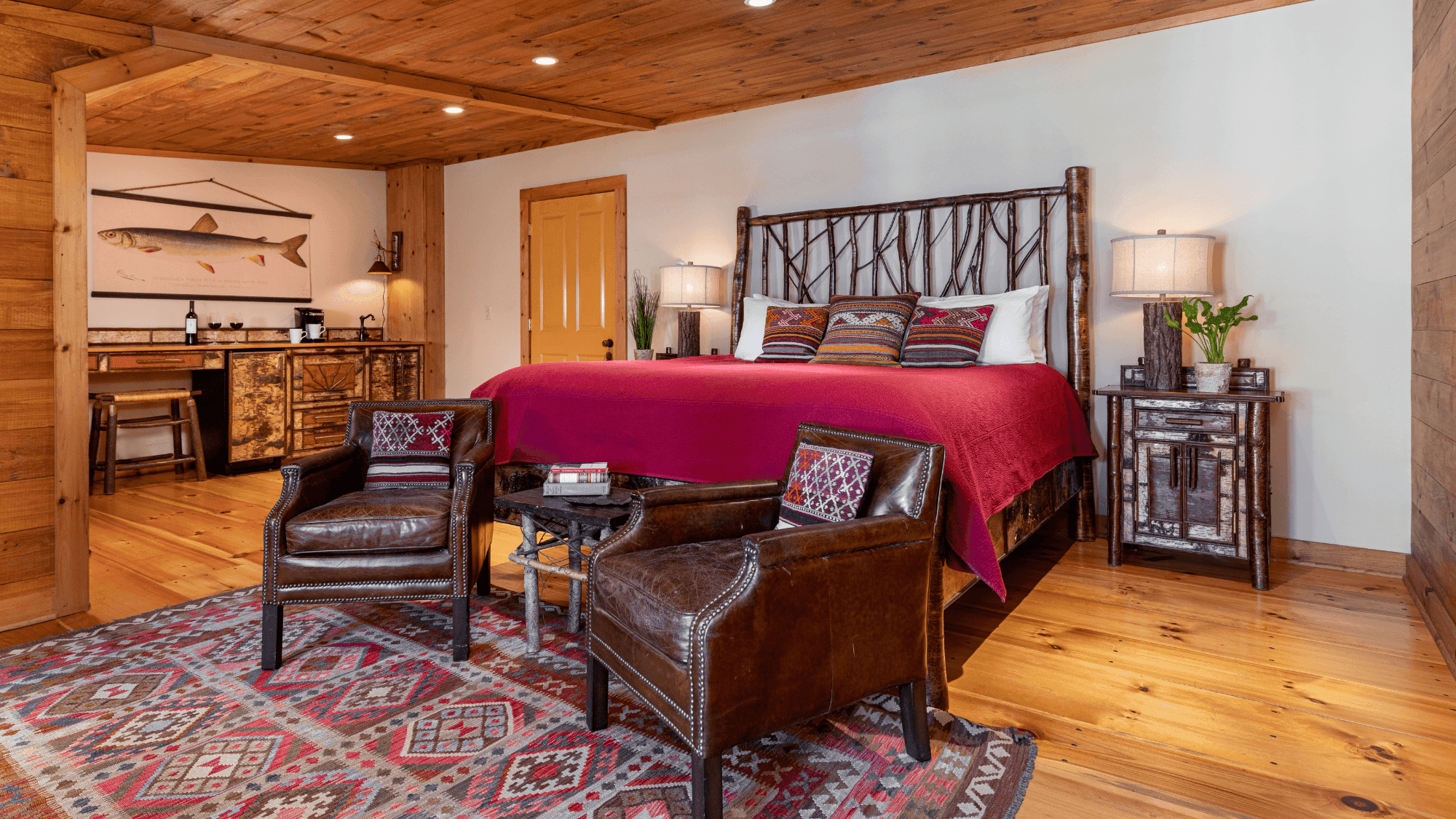 Essex Inn Room 7 with large red king bed, wood decor and two chairs