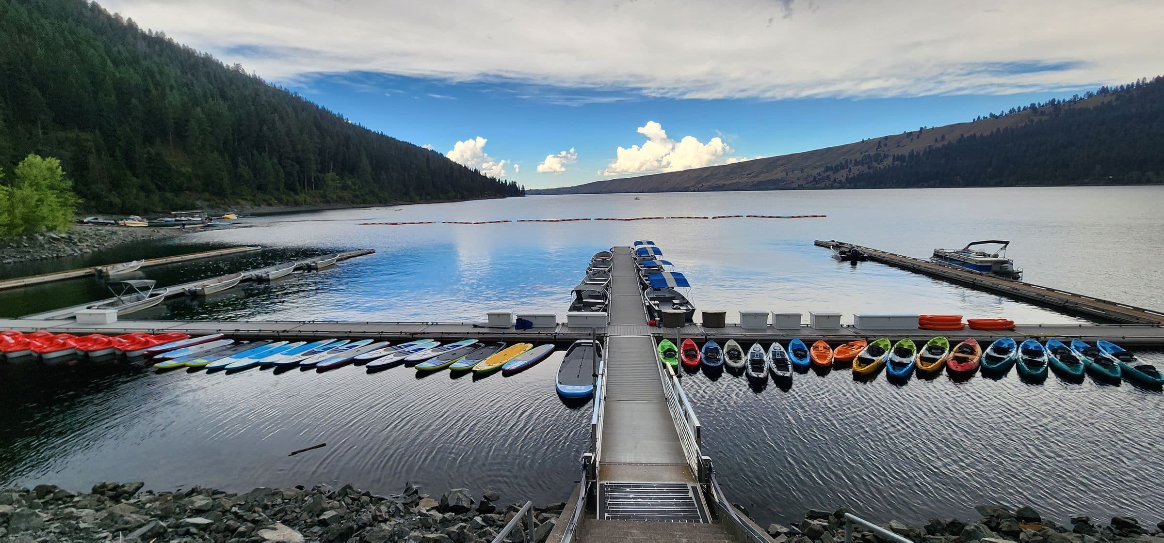 Water Sport equipment (kayaks, paddle boards) lined up at the Wallowa Lake Marina dock