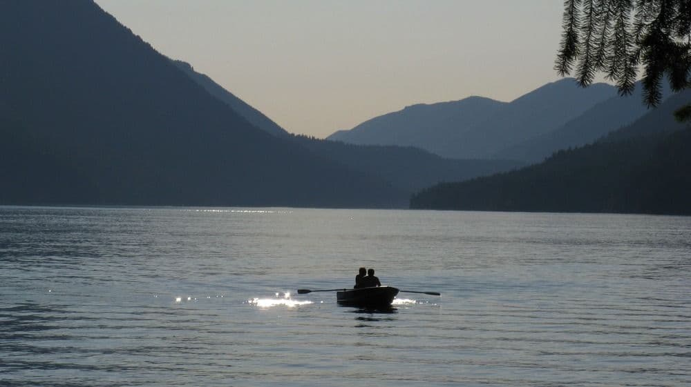 Sun Setting at Lake Crescent with sun kayakers in the distance