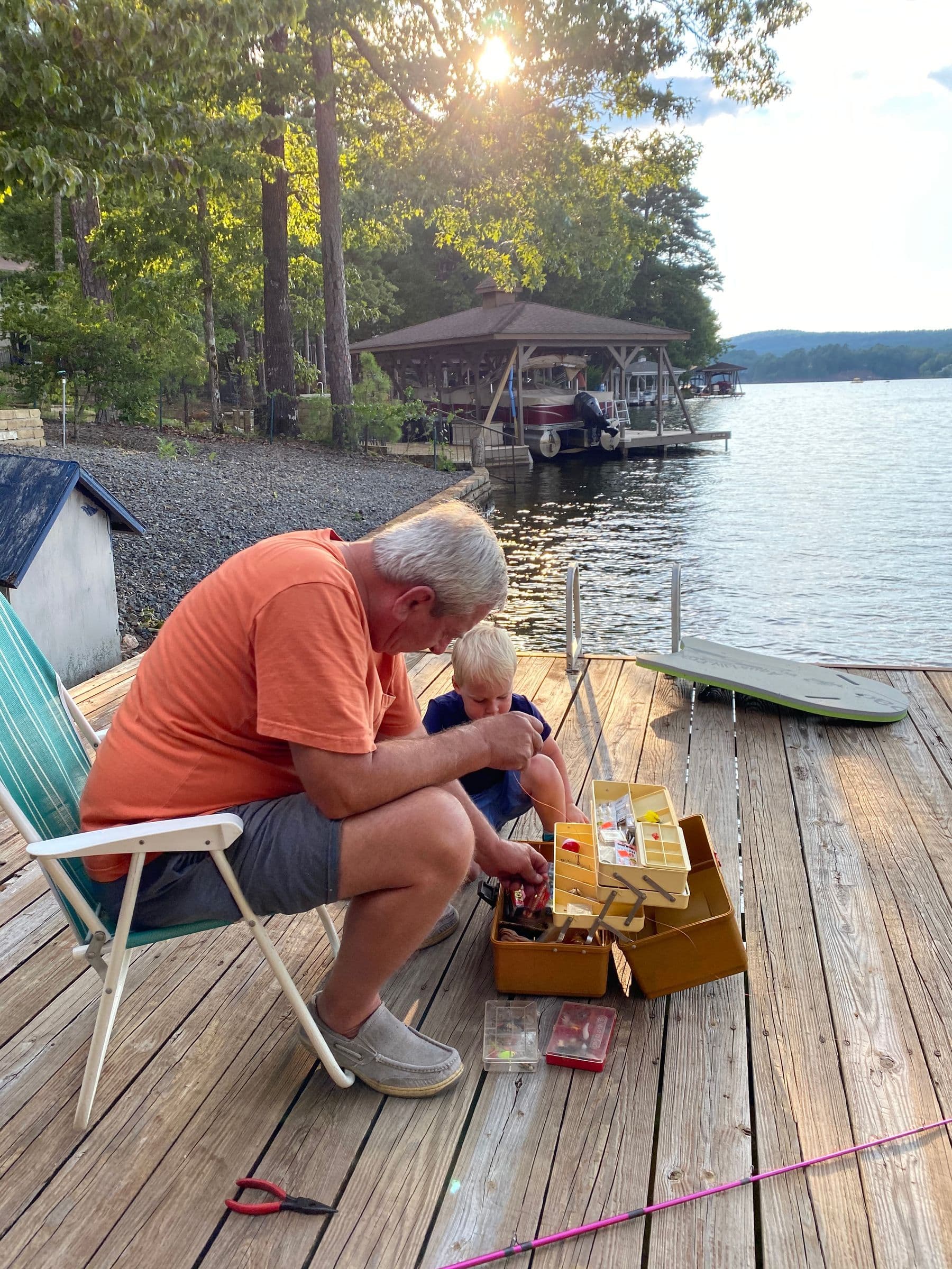 Grandpa and Grandson fishing from a dock