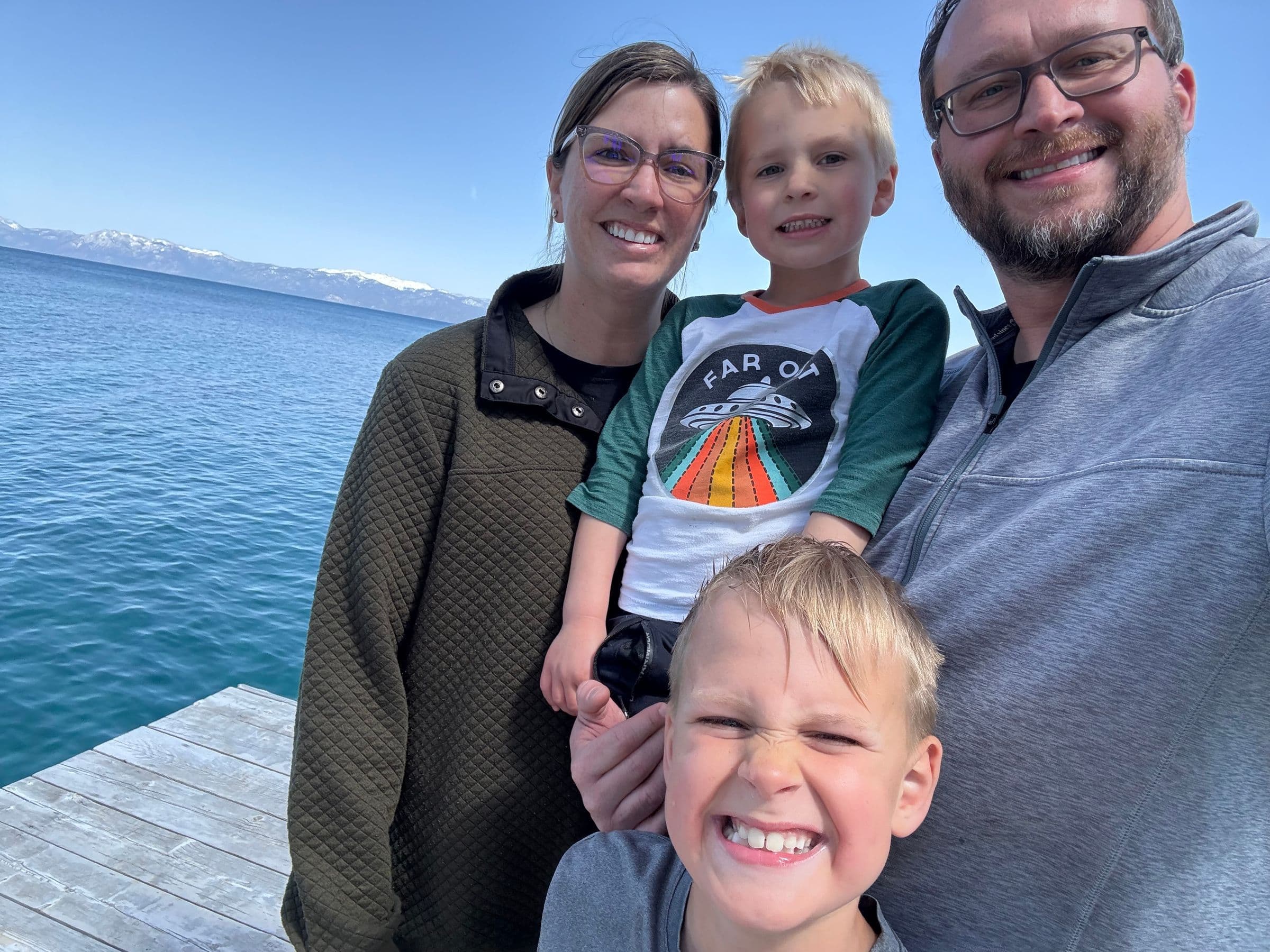 Family of 4 with two young boys on a dock at Lake Tahoe