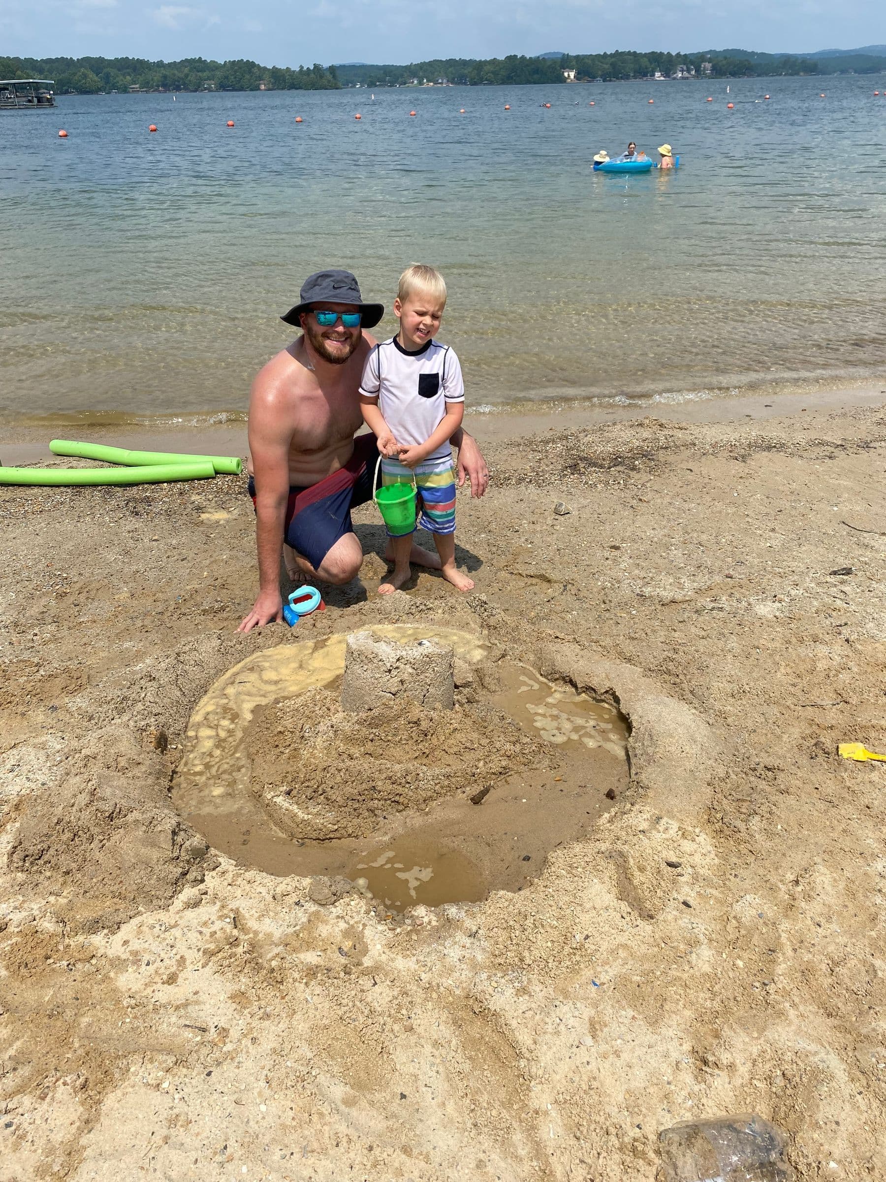 Dad and son on a lake beach