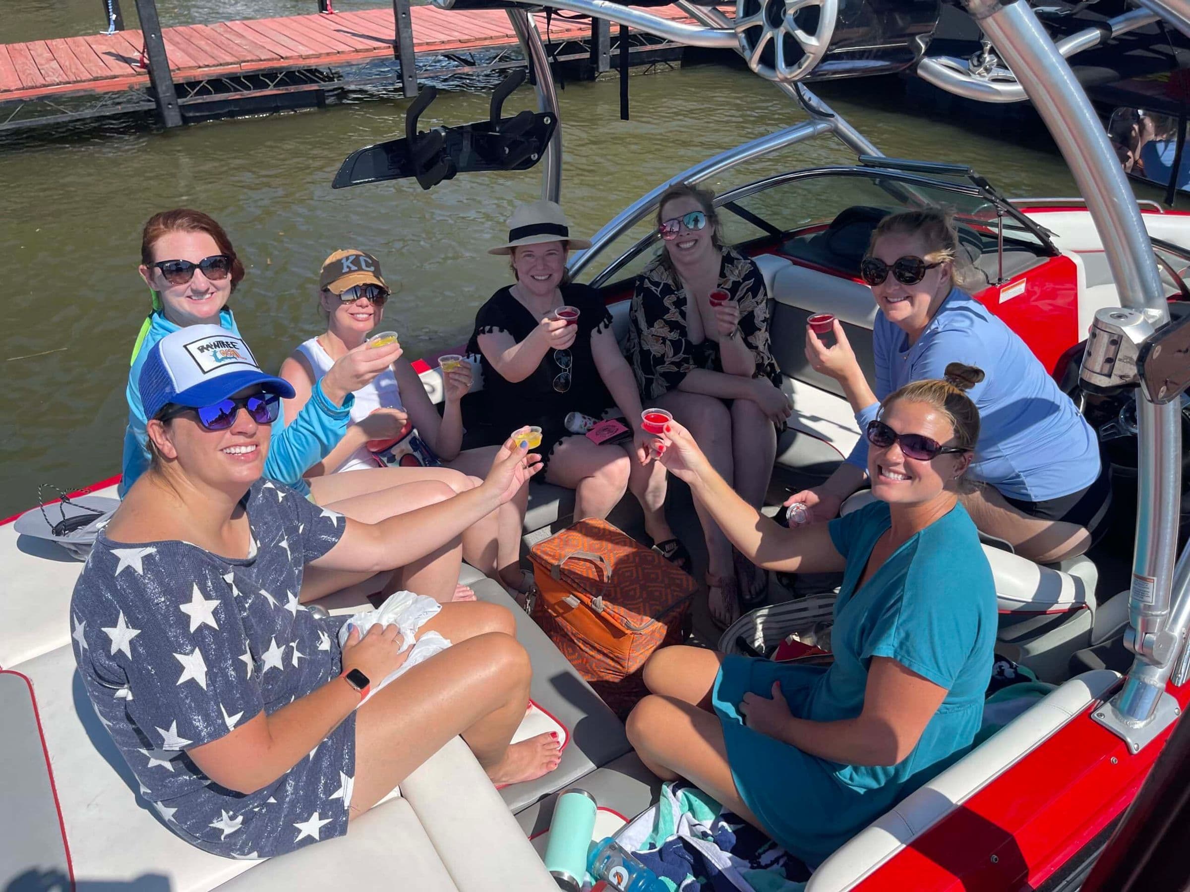 Group of girls on a boat taking shots