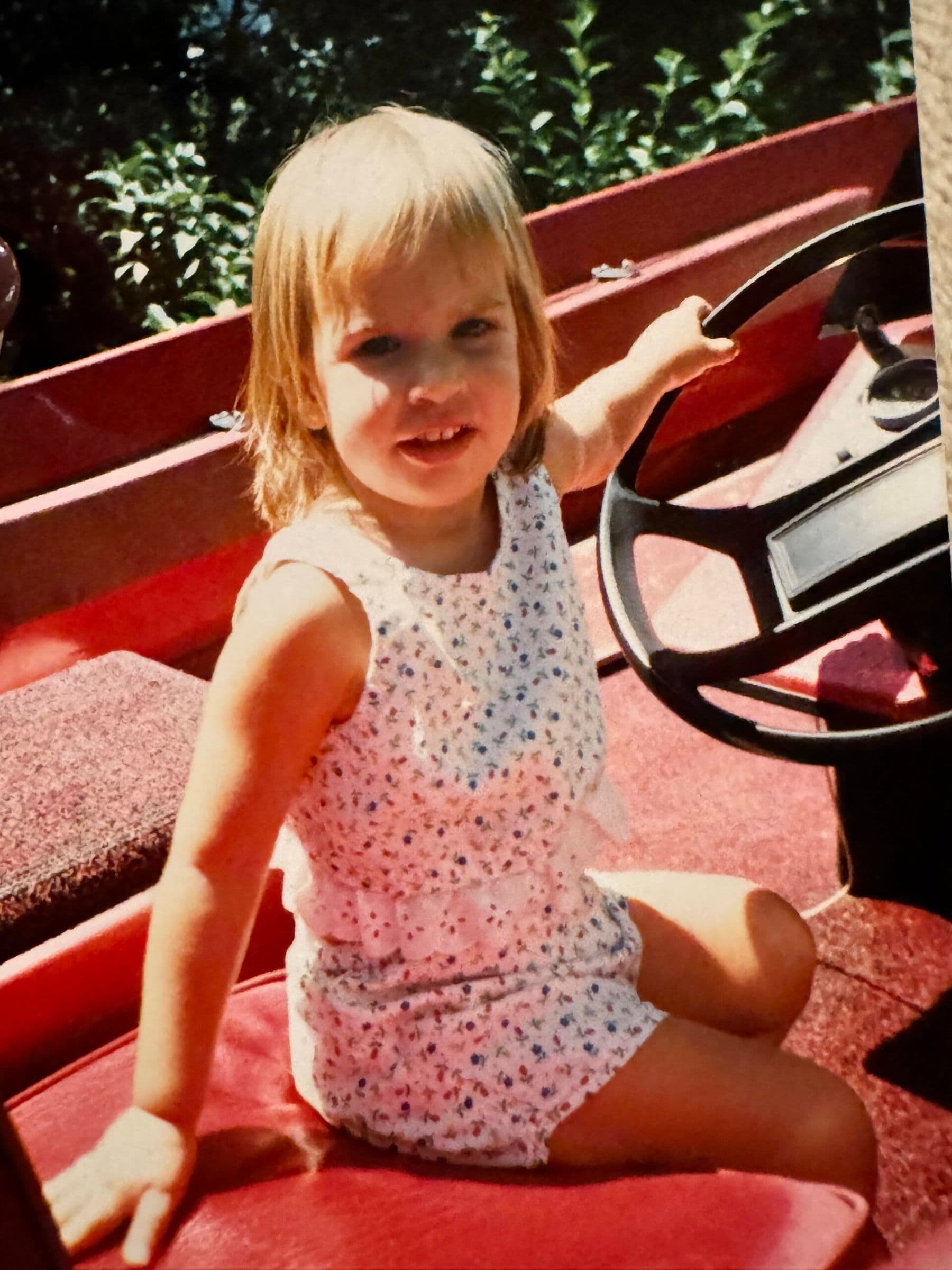 4 year old girl pretending to drive boat on Lake Altoona