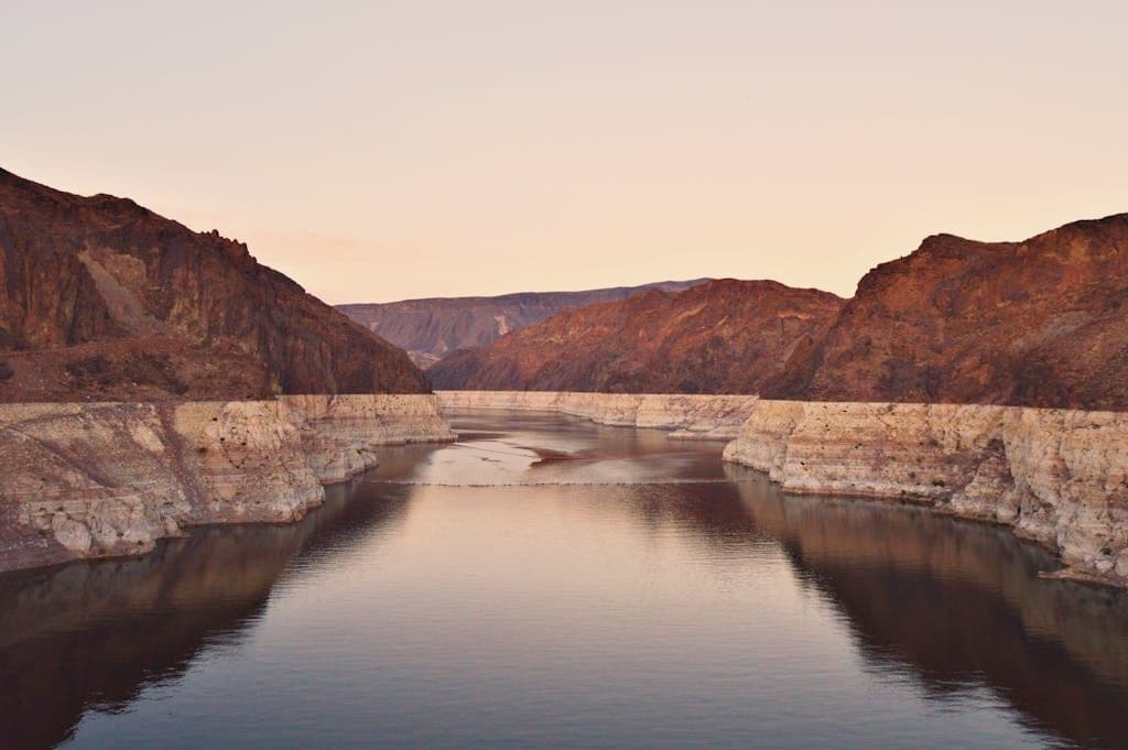 A stunning view of Lake Mead at sunset, showcasing the rocky desert landscape in Boulder City, Nevada.