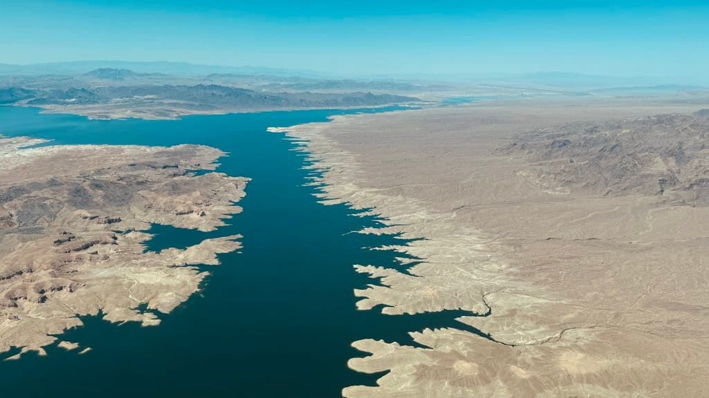 Expansive aerial view showing Lake Mead along the Colorado River with a desert landscape.