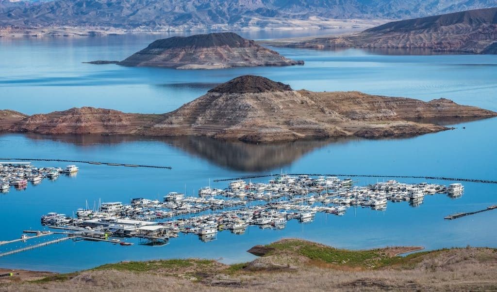 High-angle view of a busy marina at Lake Mead with vibrant blue waters and distant mountains.