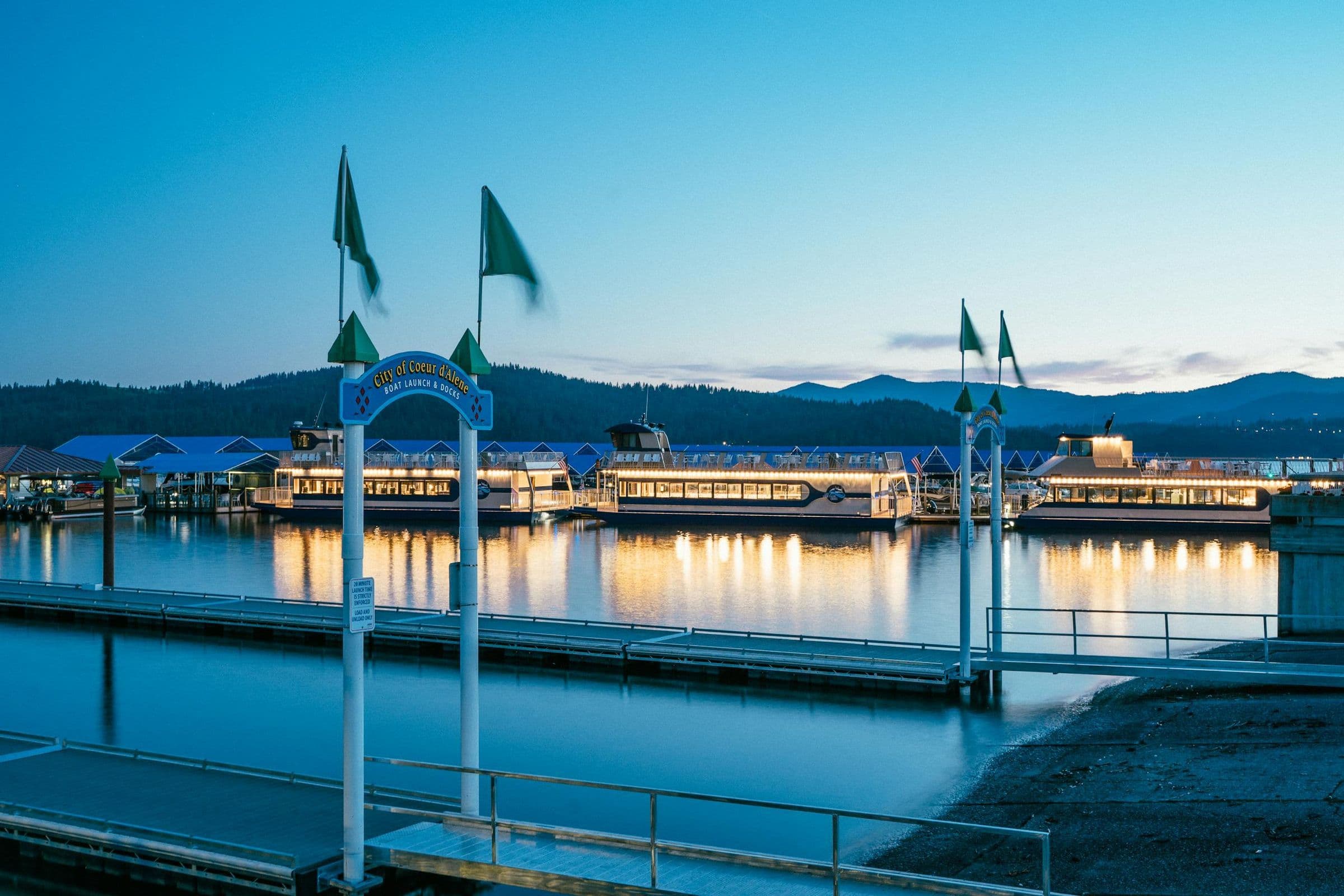Illuminated marina and dock with reflections at sunset in Coeur d'Alene, Idaho.
