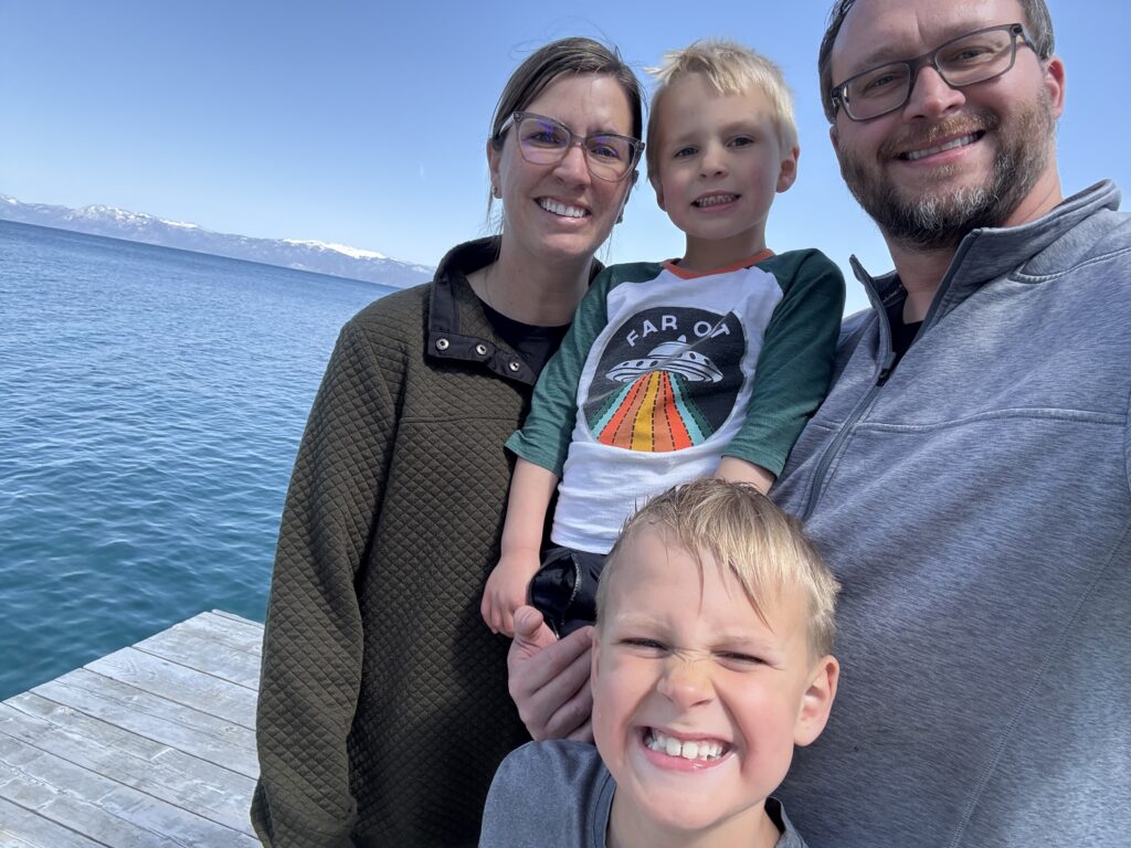 Family of 4 with two young boys on a dock at Lake Tahoe